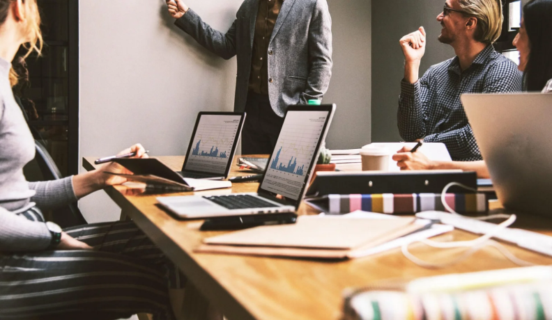 Business team discussing mesh wifi network solution strategies and data analytics for industrial applications.